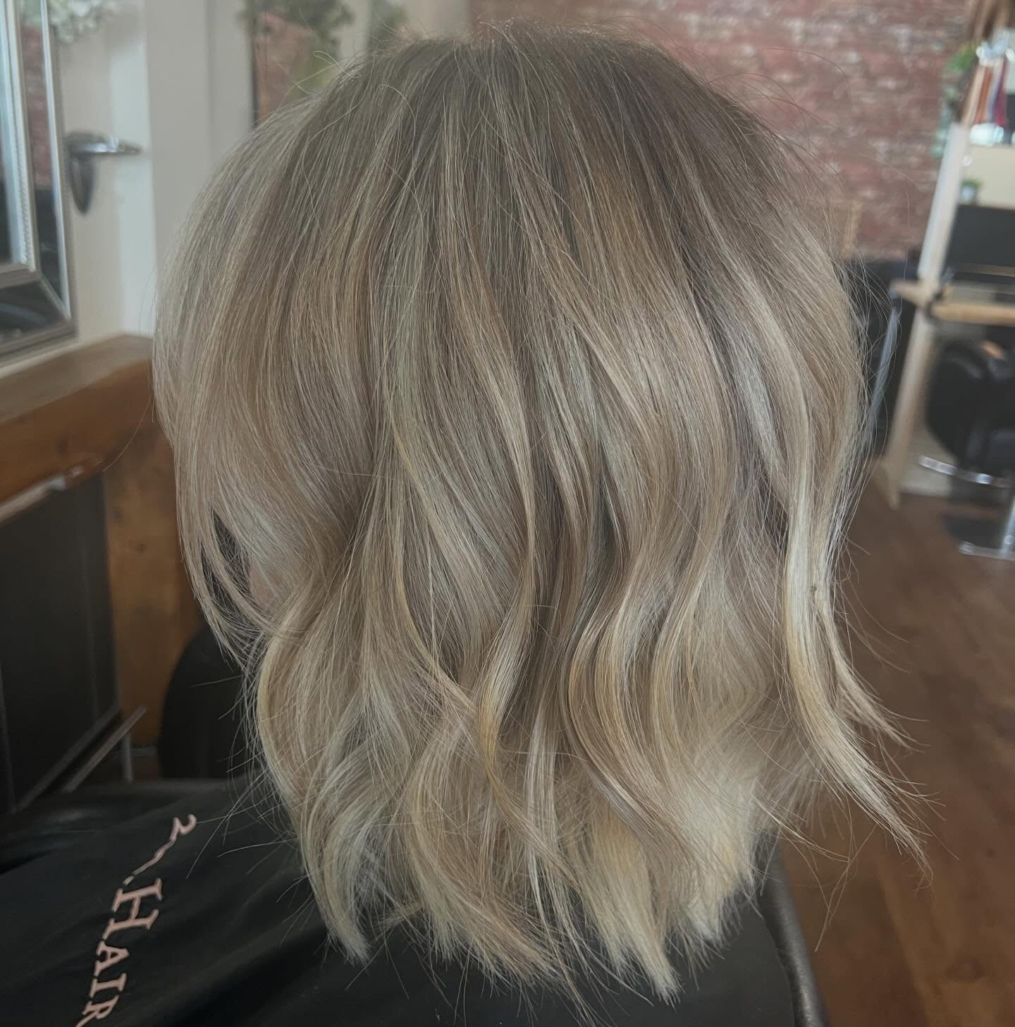 Soft, low-maintenance blonde colour by Cherina at 261.Hair